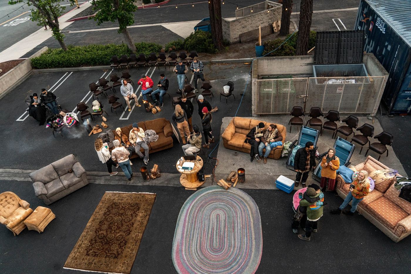 An aerial view of a Whalebird parking lot hangout, couches and fire pits set up around Knowledge Night