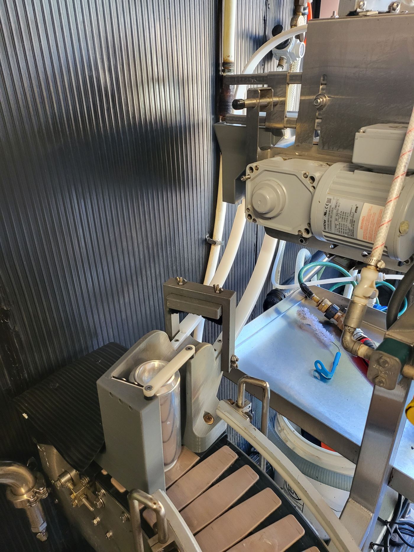 Close-up of the canning line drive motor and 3D-printed can pusher