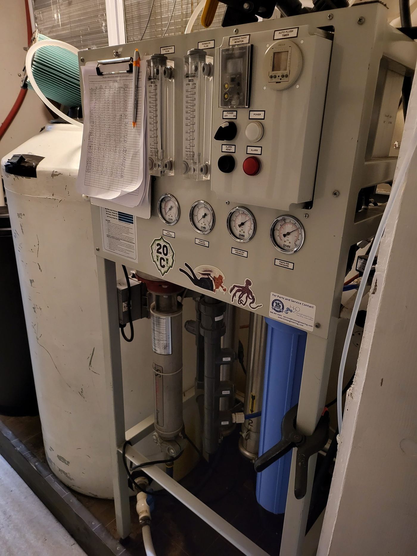 The reverse osmosis water system, gauges and flow meters with the daily log sheet on the panel