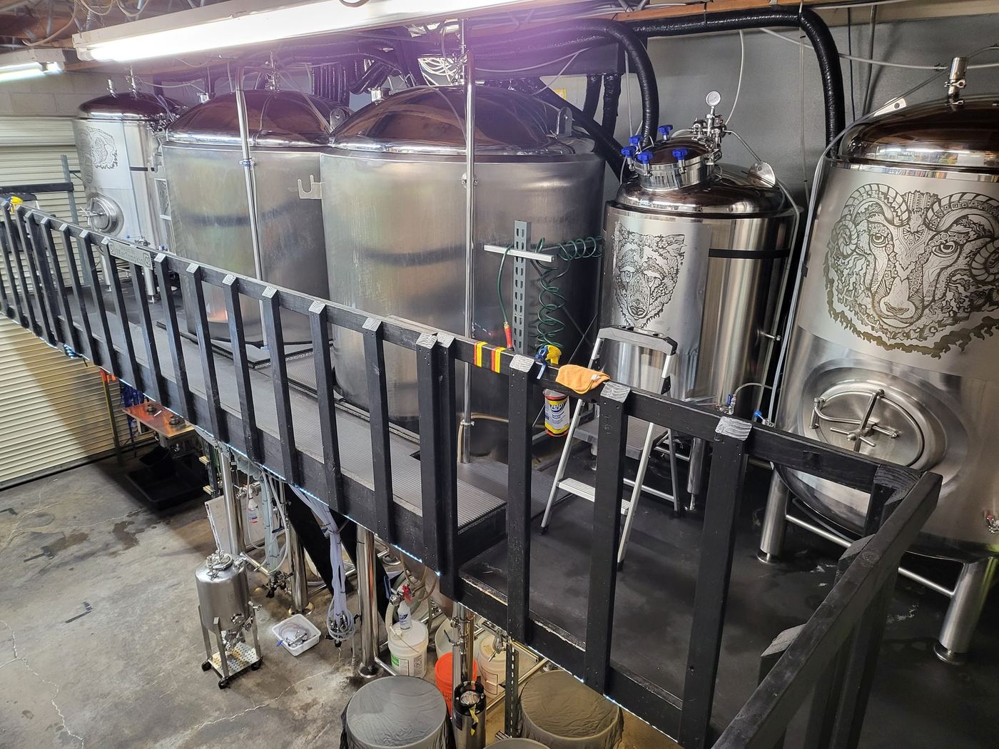 The raised catwalk running alongside the fermentation tank row, part of building production on two levels